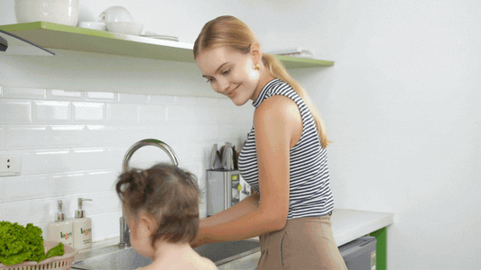 Parent and child cooking together using Montessori helper stool
