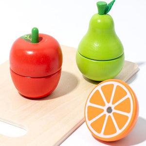 Wooden play apple, pear and orange on a chopping board
