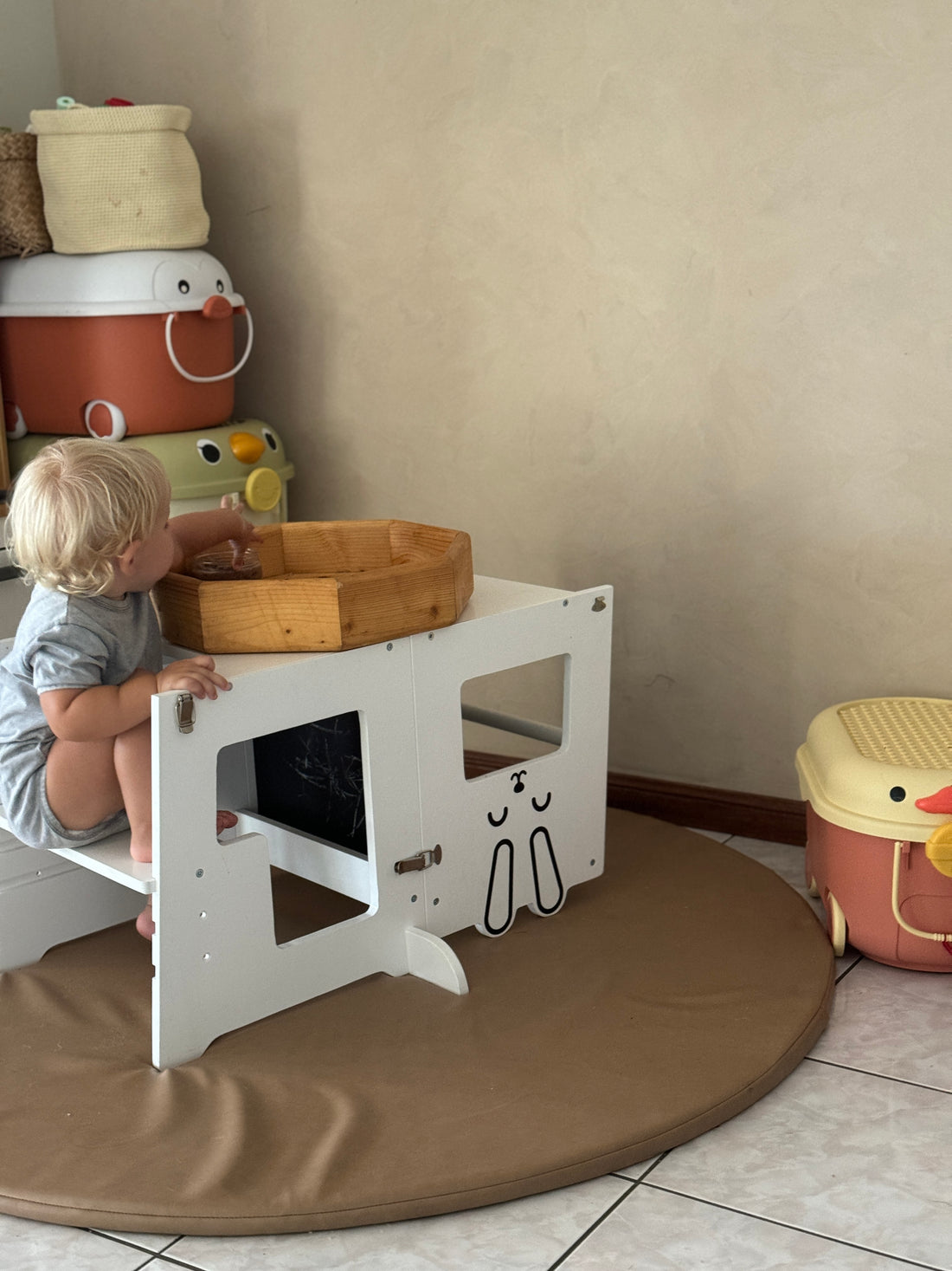 3-in-1 learning tower converted into a table and chair setup, showcasing its versatility as a space for kids’ art and creativity.