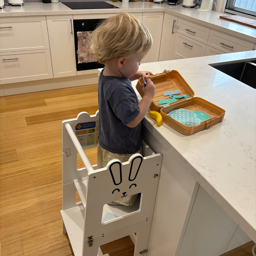 A sturdy wooden learning tower designed for toddlers, featuring a safe, non-slip platform and sleek, minimalist design. Perfect for helping little ones reach counters and explore safely during activities like cooking, cleaning, or crafts.