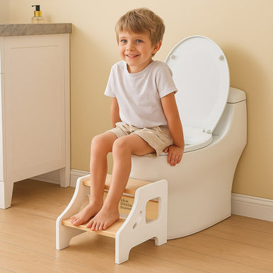 A toddler using a step stool for practicing potty 