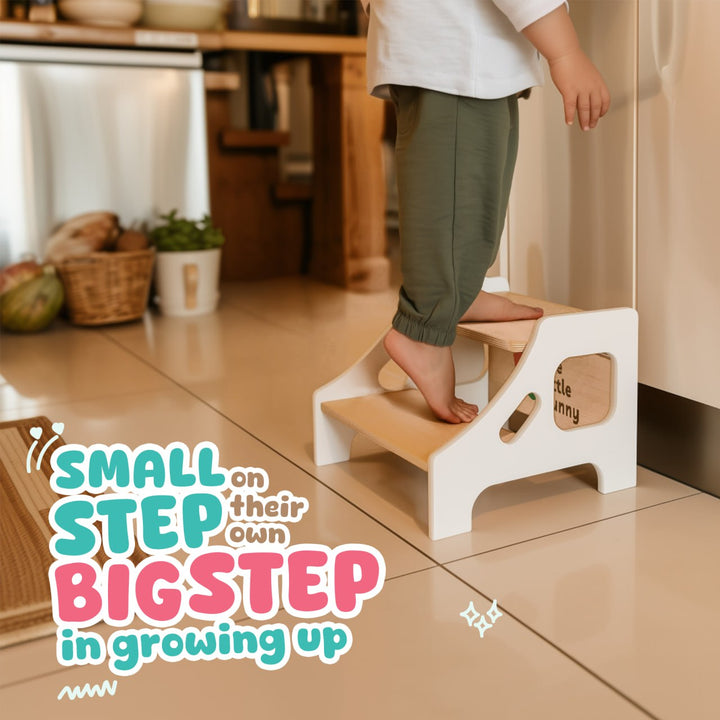 Child stepping on The Little Bunny wooden step stool in kitchen, with message 'Small step on their own, big step in growing up' in playful typography