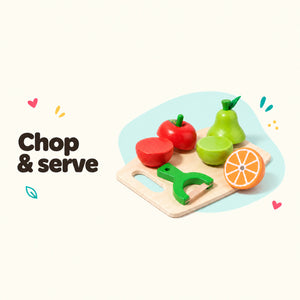 Wooden play apple and pear in halves on a chopping board with a toy knife